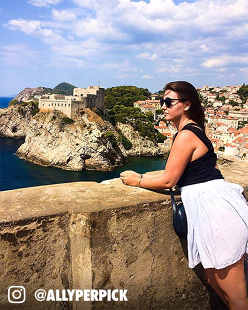 A woman in a white dress posing for a photo