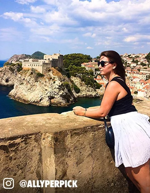 A woman in a white dress posing for a photo
