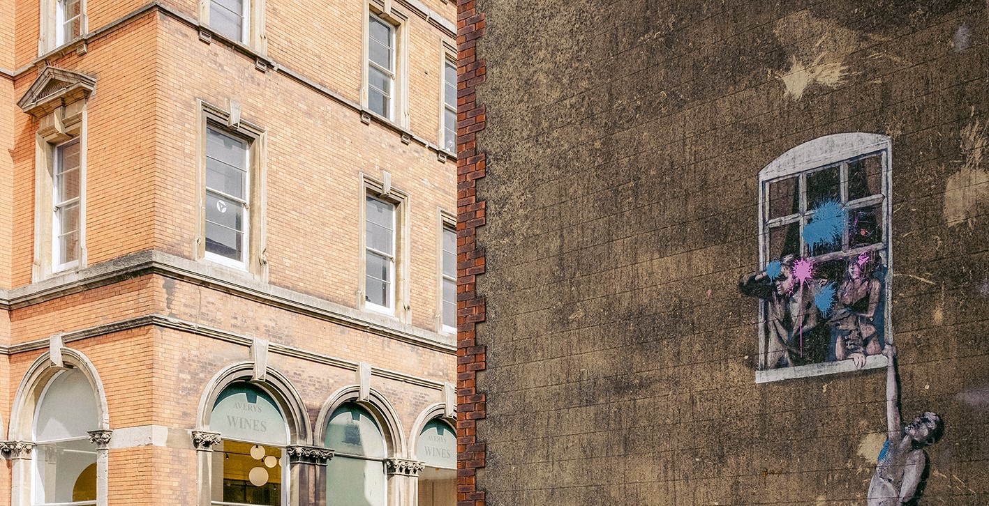 A painting by Banksy on the side of a building in Bristol, United Kingdom