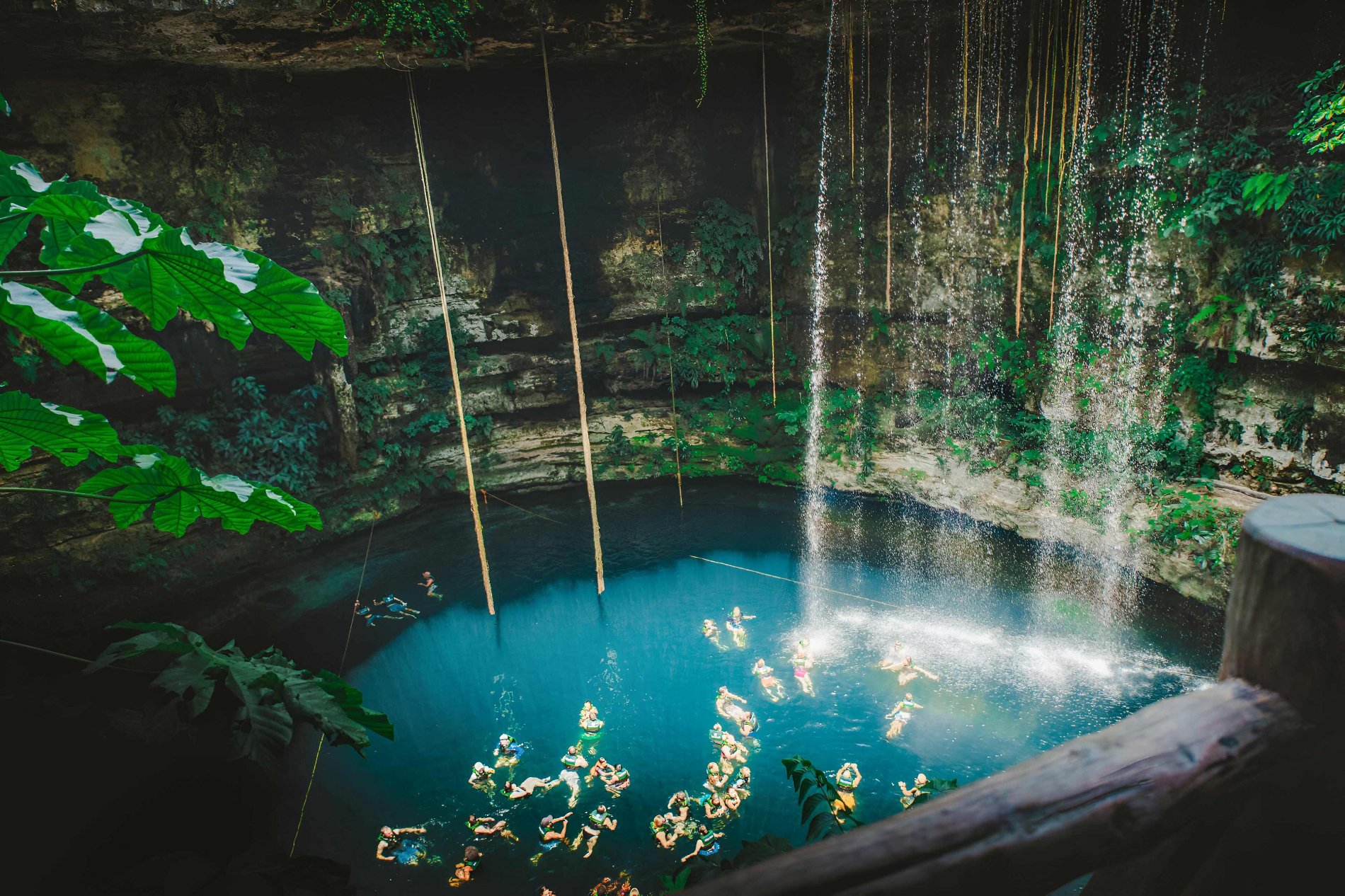 People Swimming In Cave Clear Blue Water in Mexico