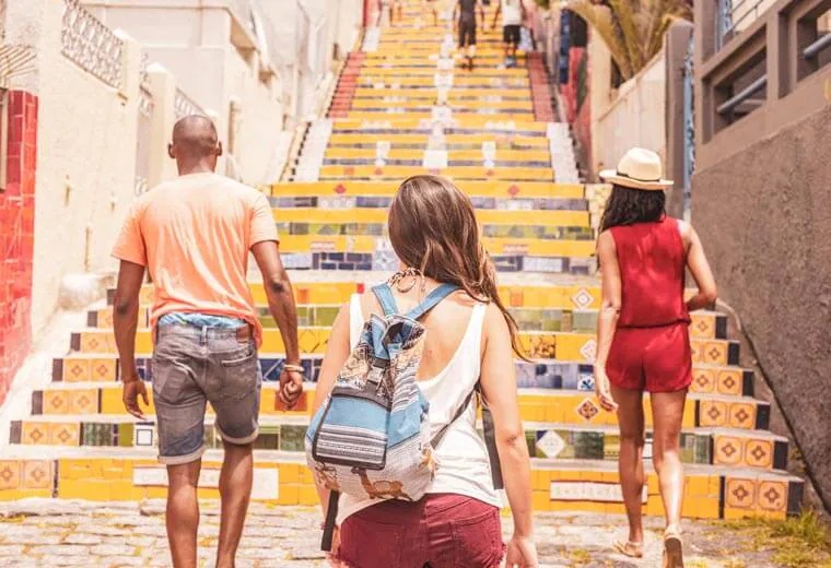 Tourist Walking on Yellow Stairs