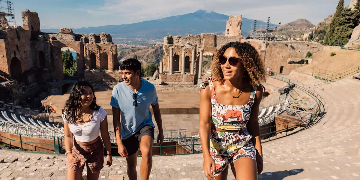 Young Group Of Travelers Exploring Ancient Sicily