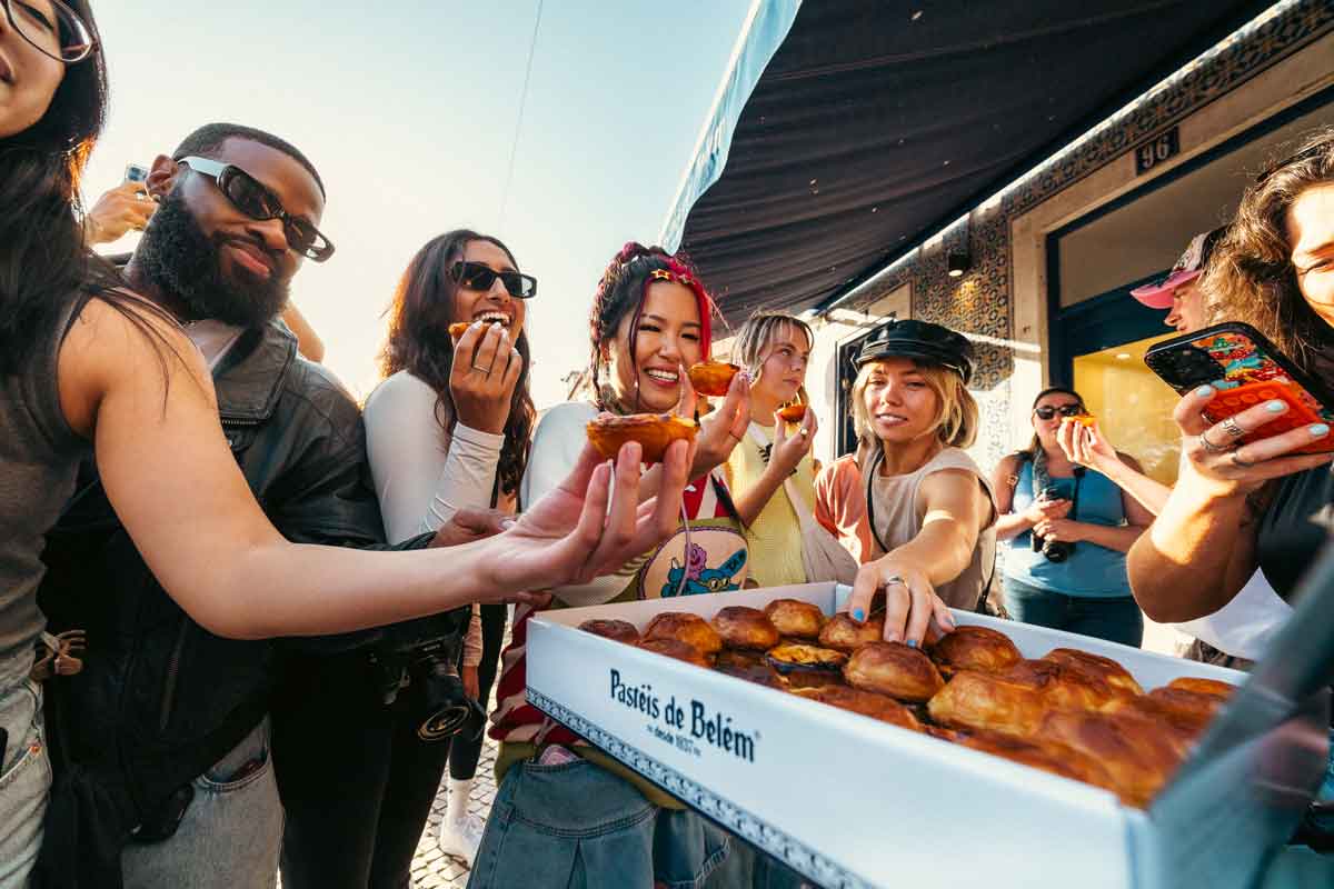 Group Of Young Friends Enjoying Pastry From Portugal