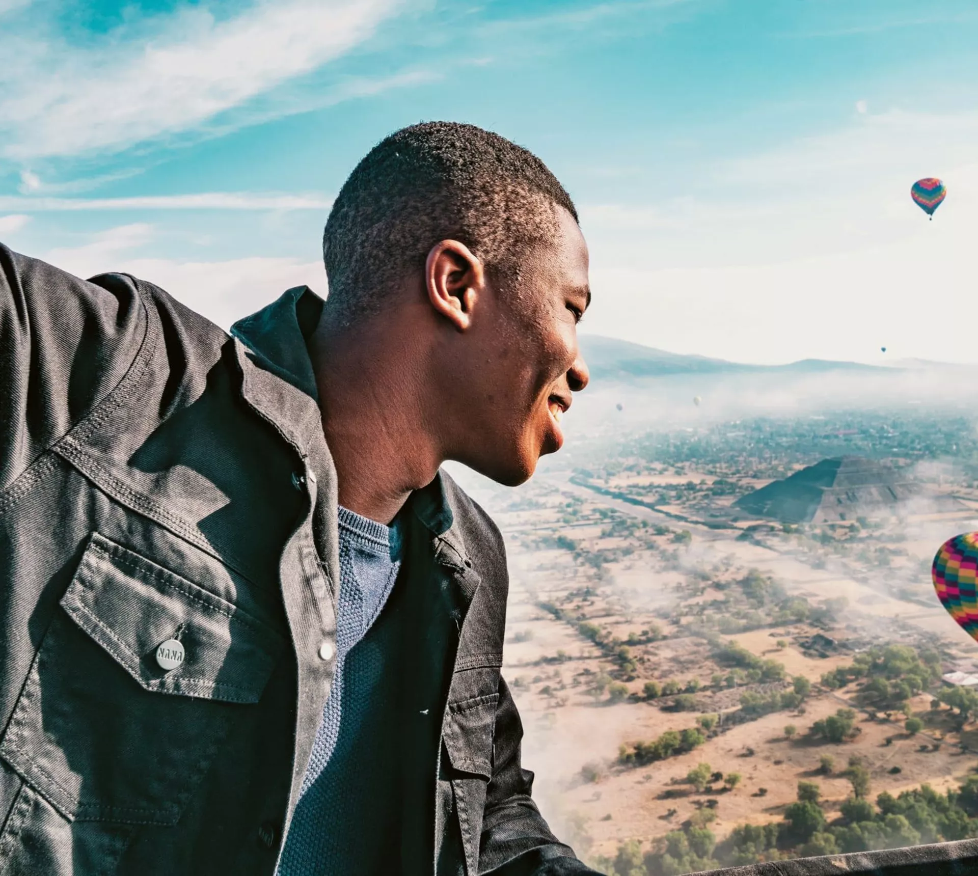 A man enjoying a hot air balloon flight over the Pyramids of Teotihuacán on Contiki's Mexican Fiesta Tour
