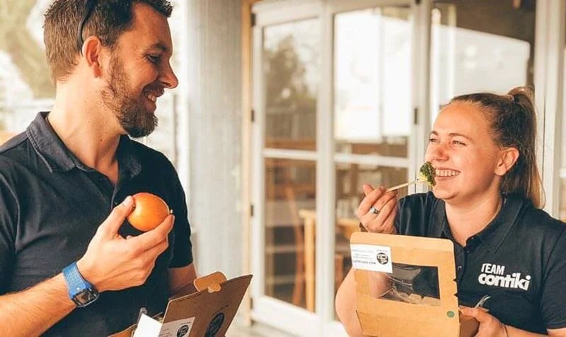 Smiling people eating fruits and vegetables