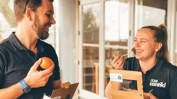 Smiling people eating fruits and vegetables