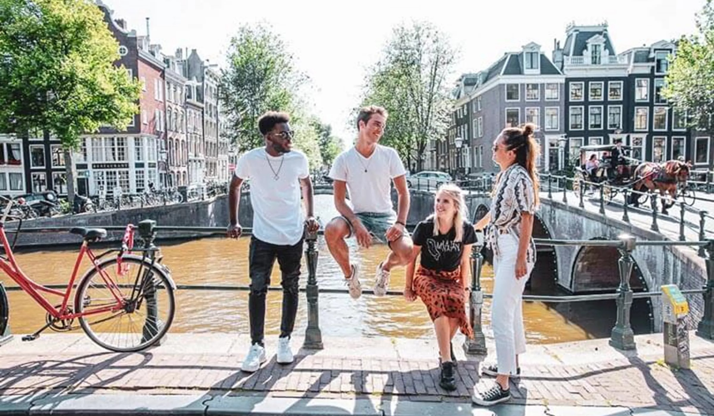 Group of people near the bridge over canal in Amsterdam, Netherlands