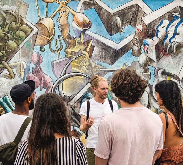 A group of young people on the background of street art