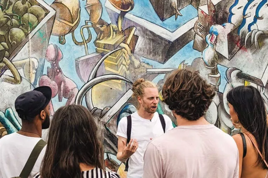 A group of young people on the background of street art