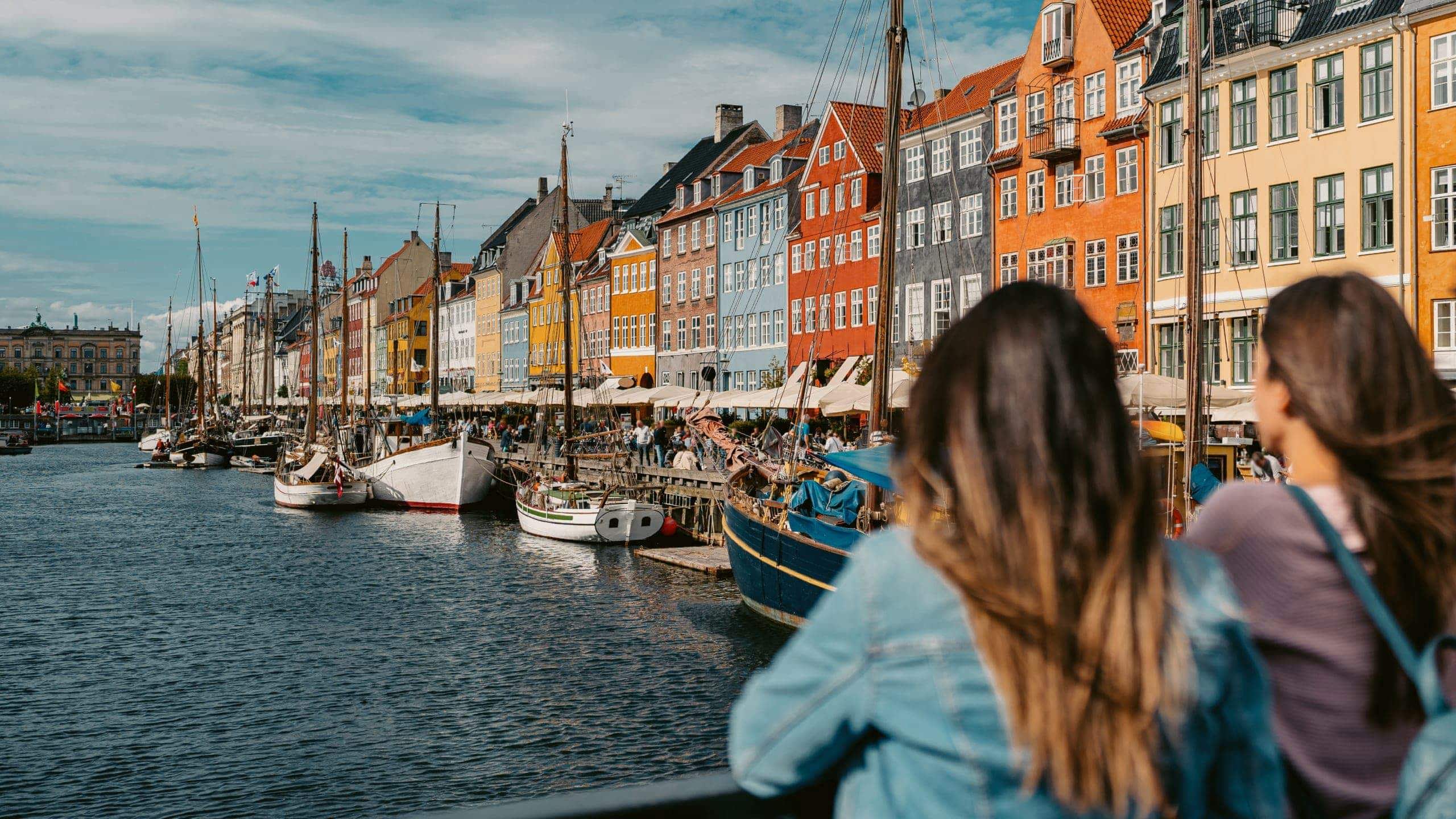 Two girls overlooking Nyhavn harbour in Copenhagen, Denmark - Contiki Best of Scandinavia Tour