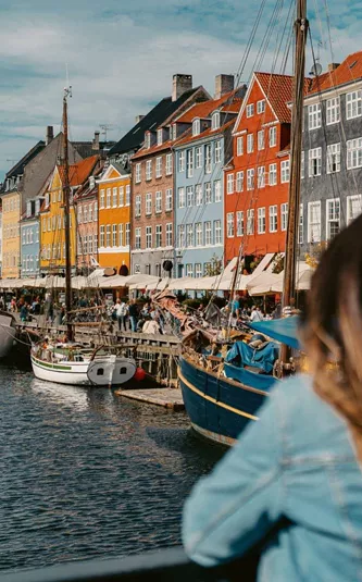 Two girls overlooking Nyhavn harbour in Copenhagen, Denmark - Contiki Best of Scandinavia Tour