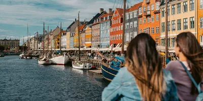 Two girls overlooking Nyhavn harbour in Copenhagen, Denmark - Contiki Best of Scandinavia Tour