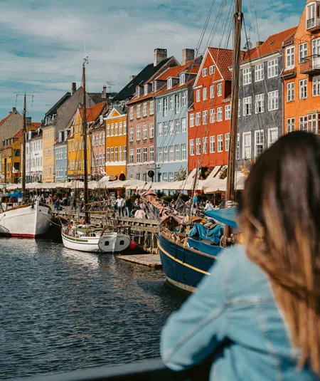 Two girls overlooking Nyhavn harbour in Copenhagen, Denmark - Contiki Best of Scandinavia Tour