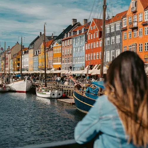 Two girls overlooking Nyhavn harbour in Copenhagen, Denmark - Contiki Best of Scandinavia Tour