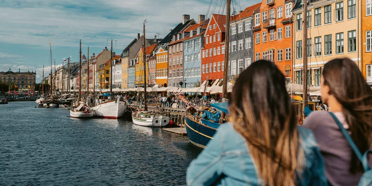 Two girls overlooking Nyhavn harbour in Copenhagen, Denmark - Contiki Best of Scandinavia Tour