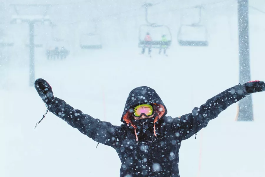 Person With Their Hands Up Snow Falling