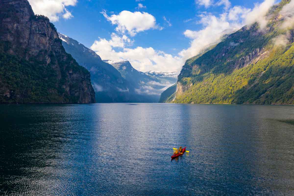 Red Kayak In Geirangerfjord Near Geiranger Moere Og Romsdal, Norway