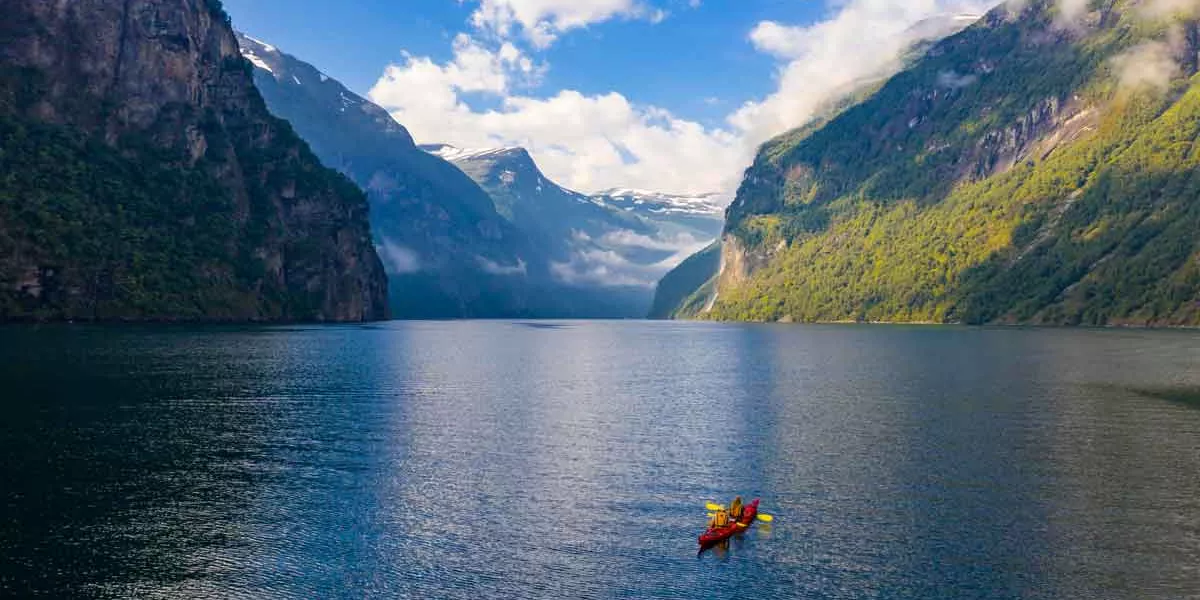 Red Kayak In Geirangerfjord Near Geiranger Moere Og Romsdal, Norway
