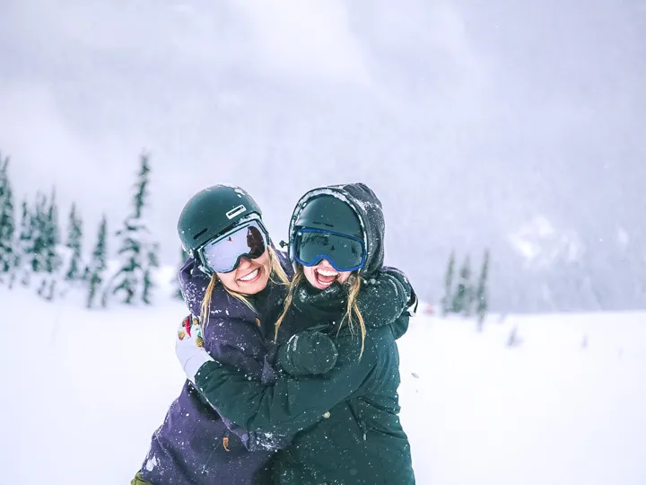 2 persons are enjoying and having fun in snow