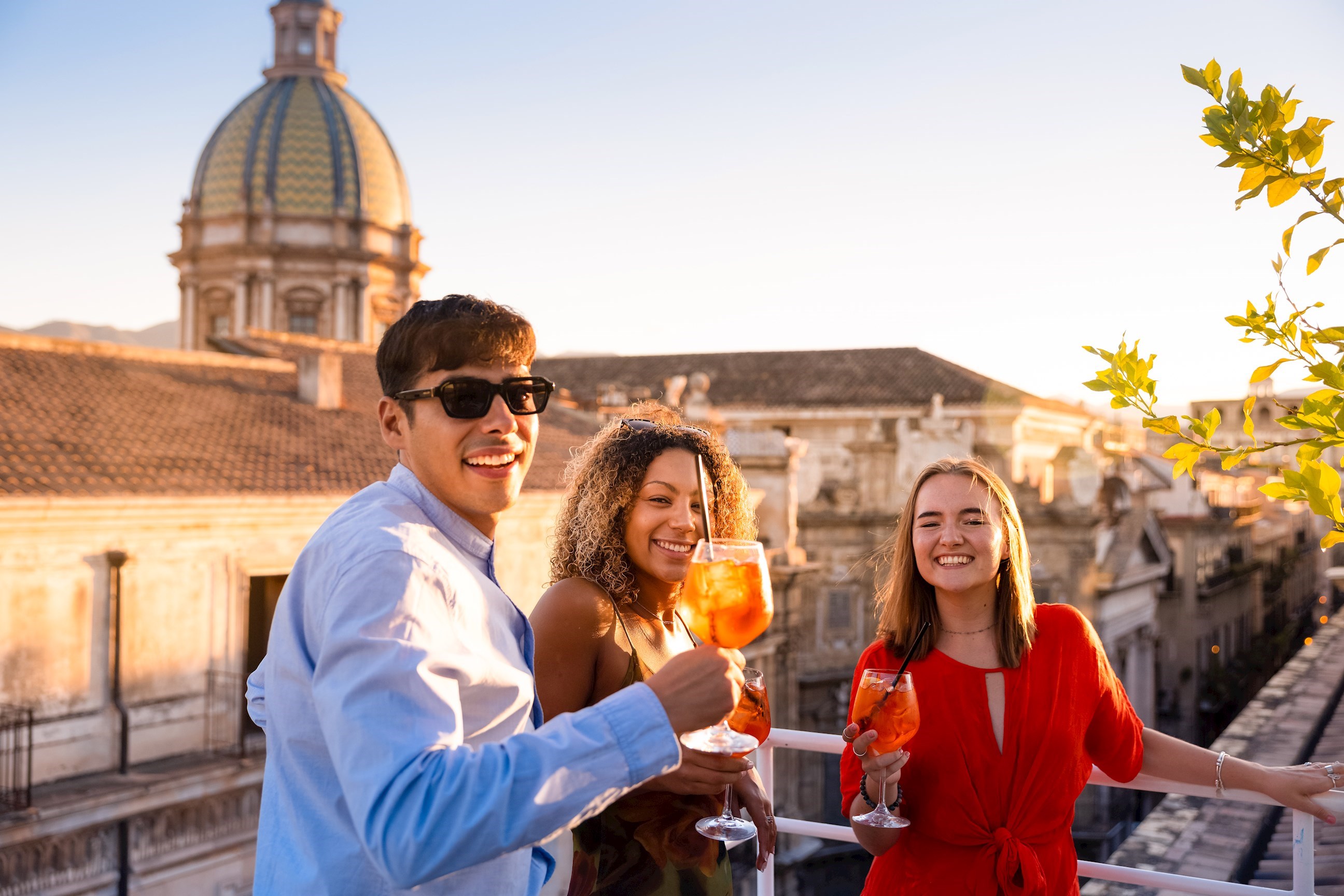 Travelers Enjoying an Aperol Spritz during Sunset, Sicily, Italy