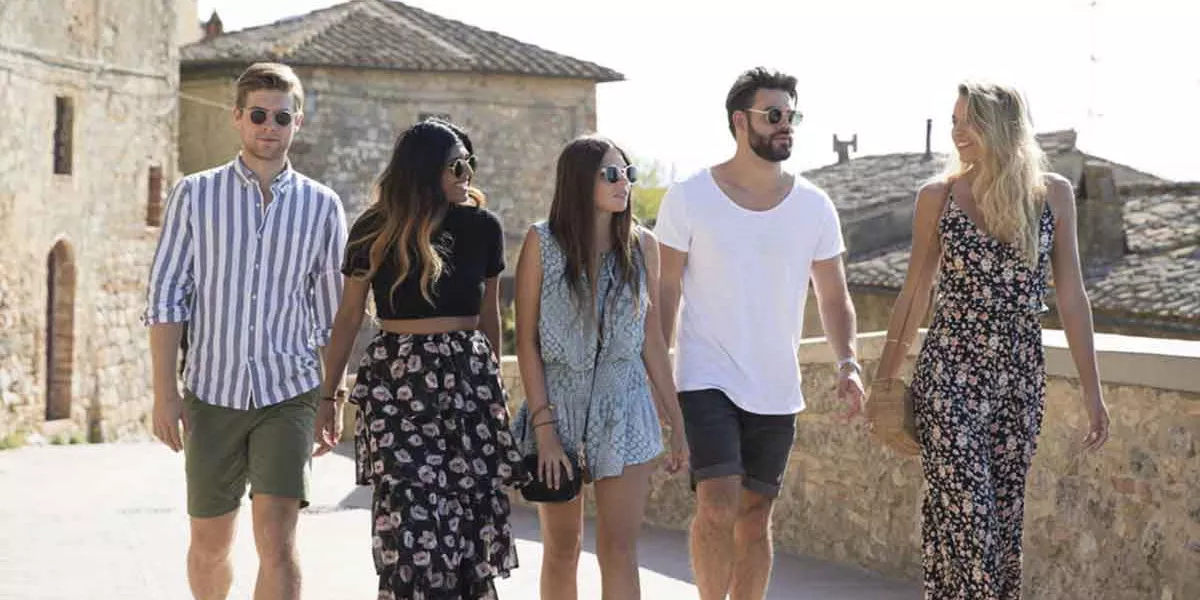 Group Of Young Travelers Walking In The Sun