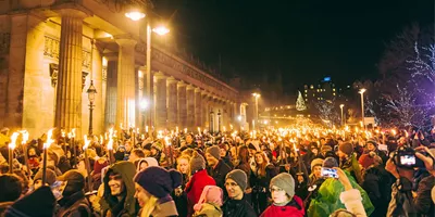 Contiki travellers joining the famous Edinburgh Hogmanay Torchlight Procession with thousands of torch-bearing revellers outside the Royal Scottish Academy at night