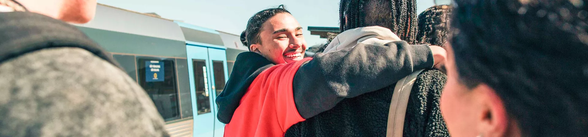 Group Of Young Travelers On Train Platform