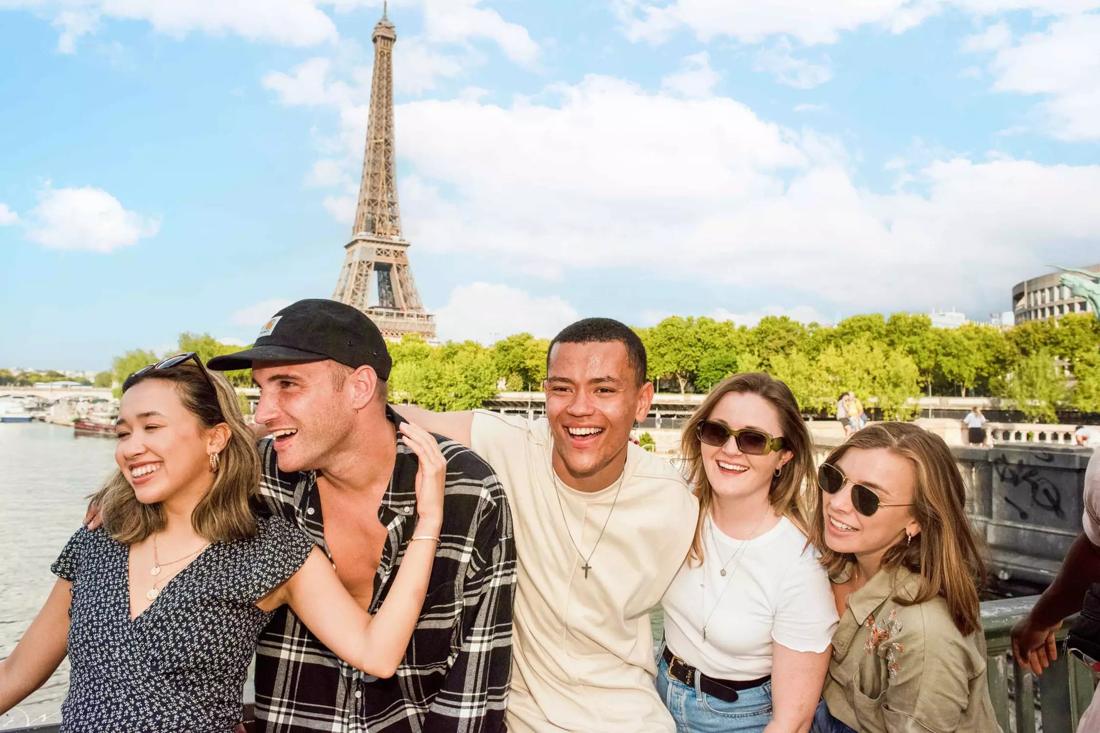 Group Of Travelers Having Fun In The Sun Near The Eiffel Tower Paris France