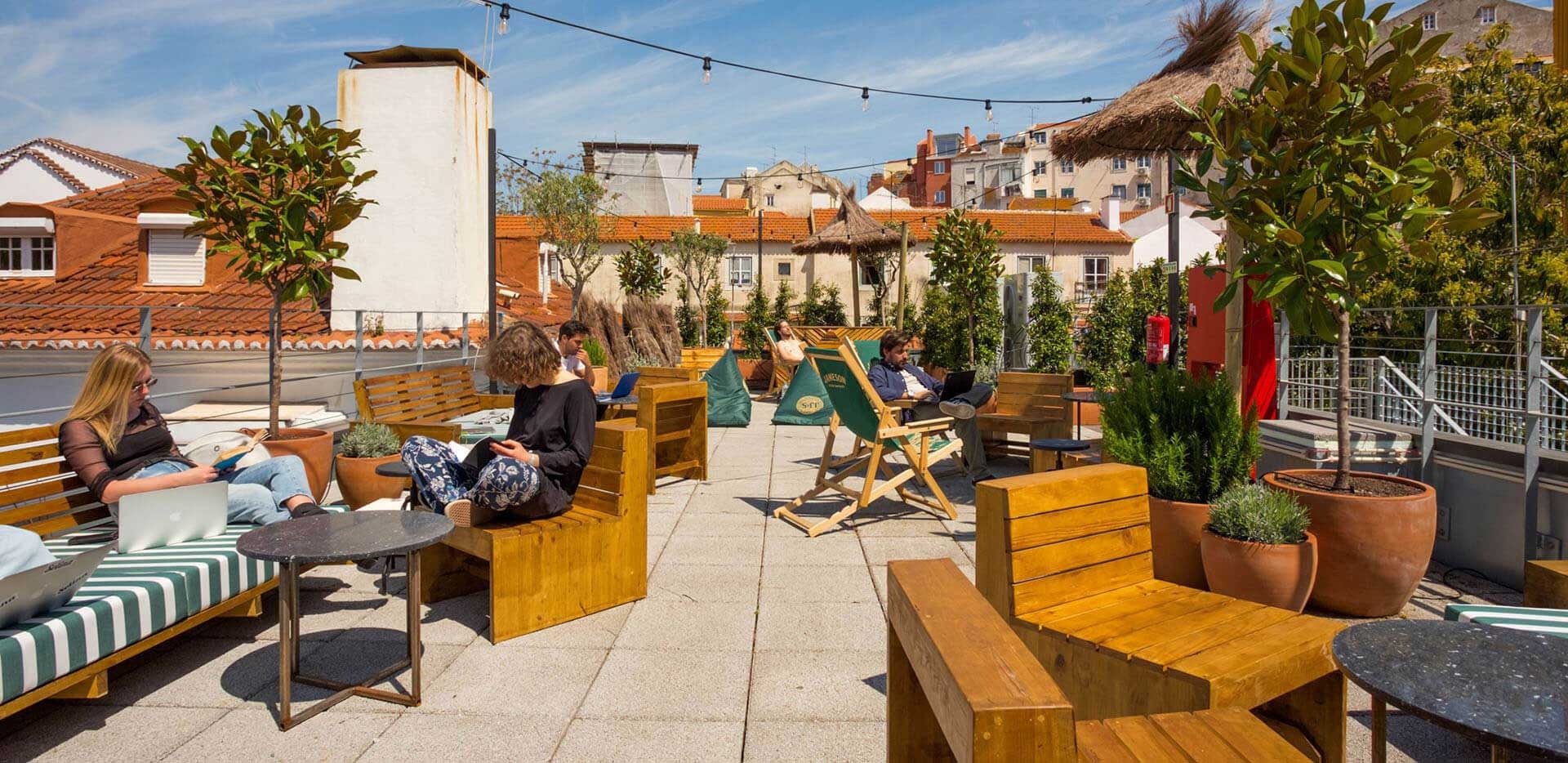 People relaxing on balcony during sunny day