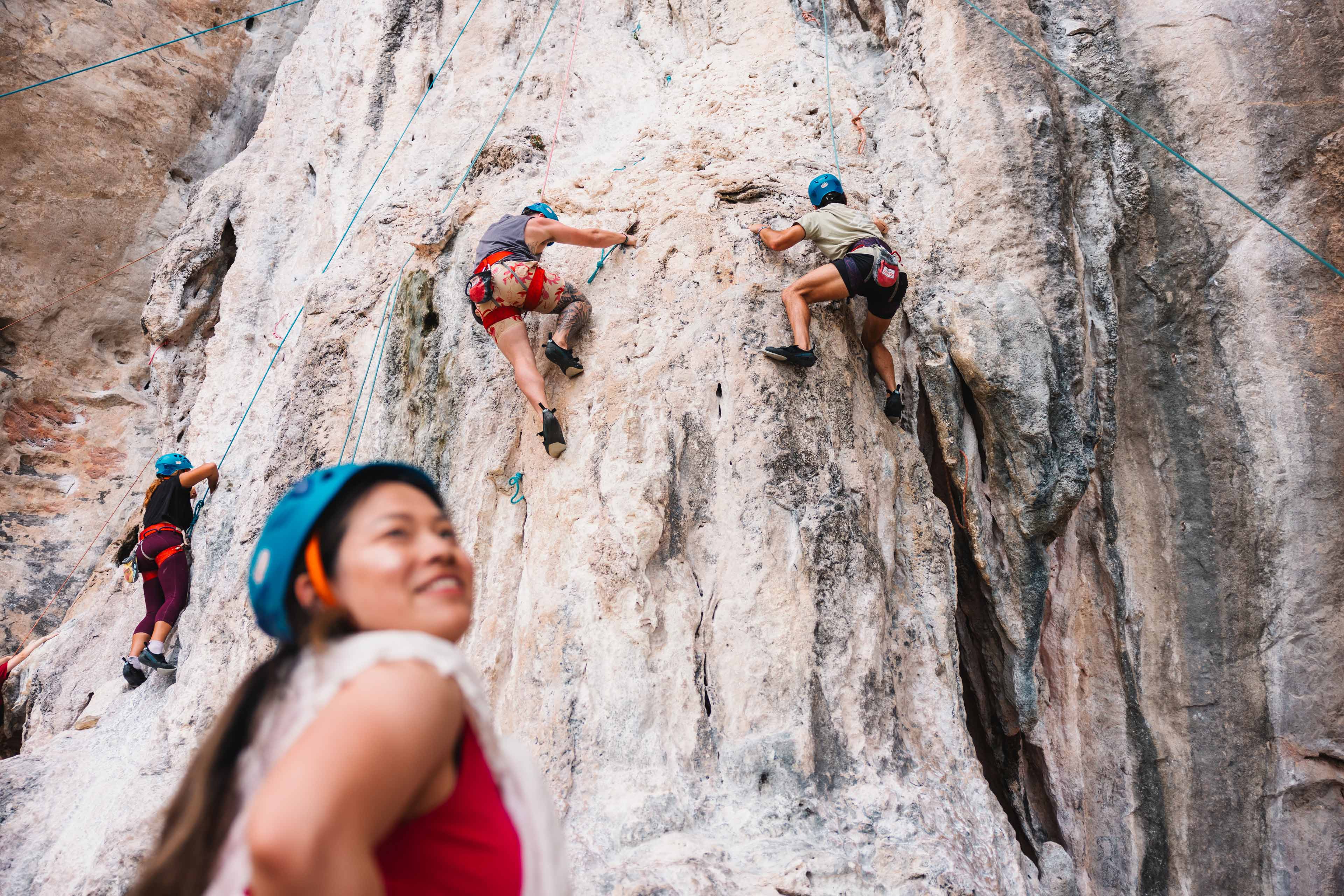 Group Climing A Cliff In Krabi