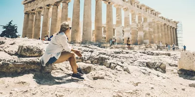 Contiki traveller admiring the Parthenon atop the Acropolis in Athens, Greece, on the Ultimate European Plus Egypt Tour
