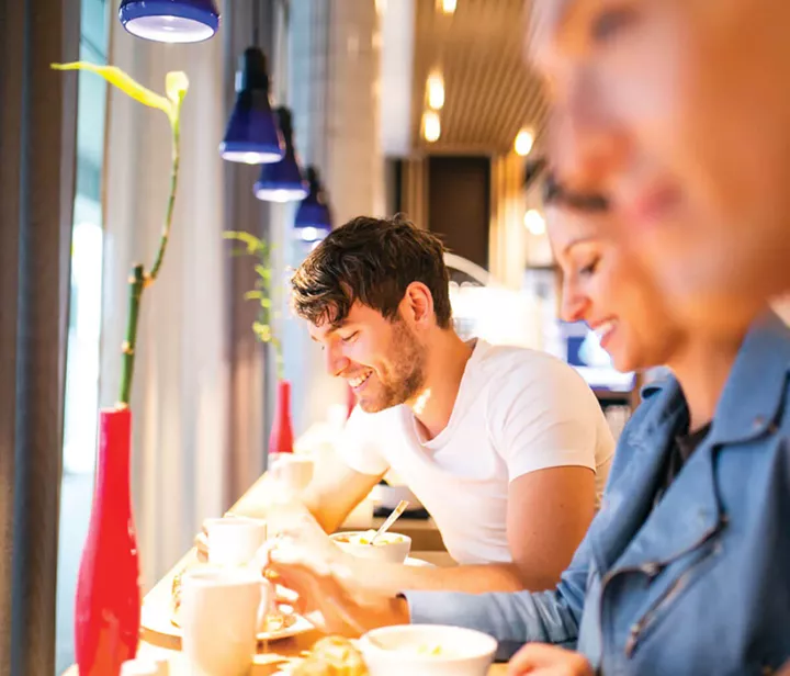 Tourists relaxing with coffee and snacks