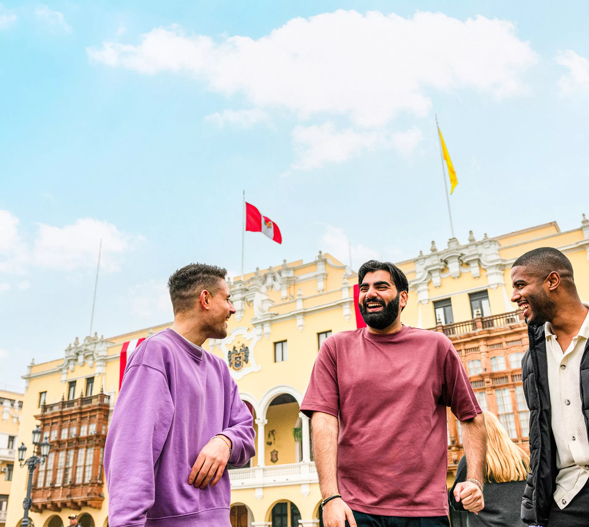 Three travellers chatting standing in Plaza Mayor de Lima, Peru