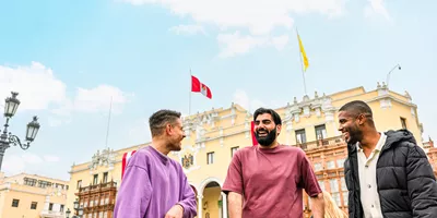 Three travellers chatting standing in Plaza Mayor de Lima, Peru