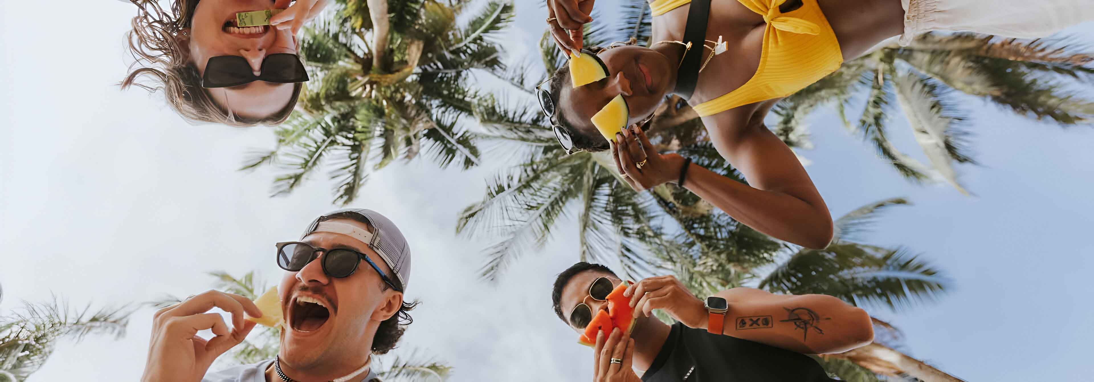 Happy Young People Holding Fruits And Smiling