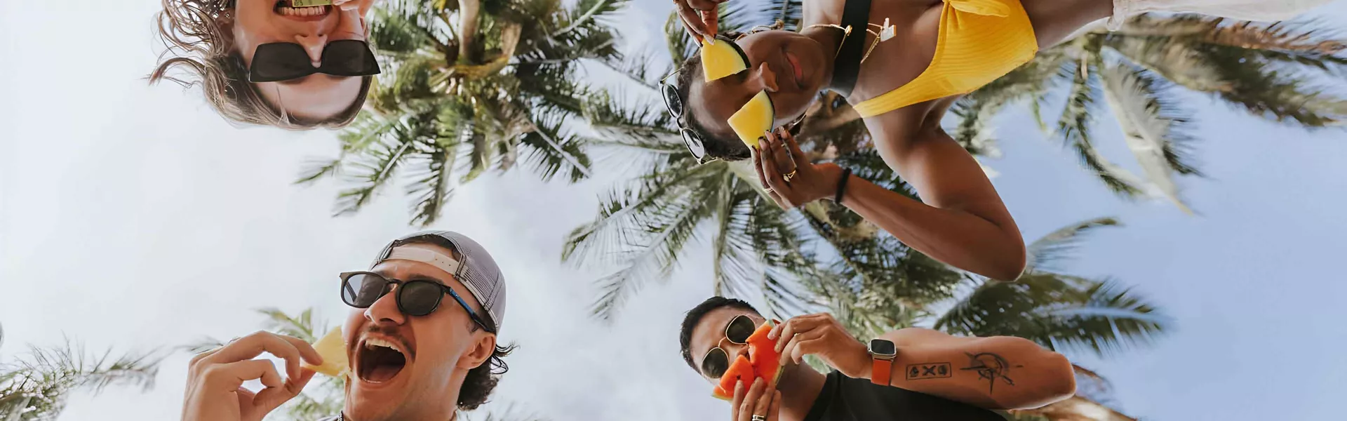 Happy Young People Holding Fruits And Smiling