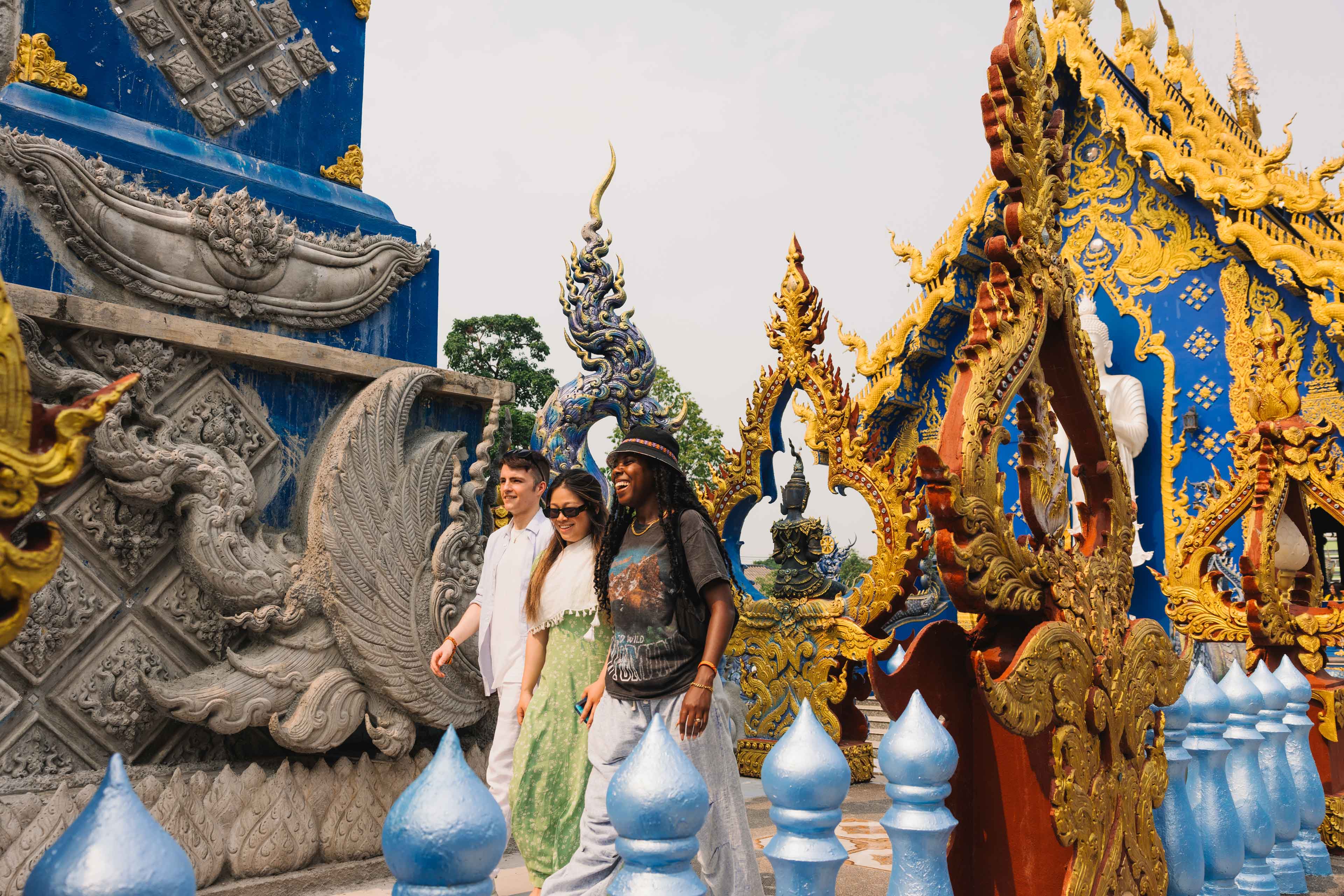 Travellers Walking In Front Of Temples In Thailand