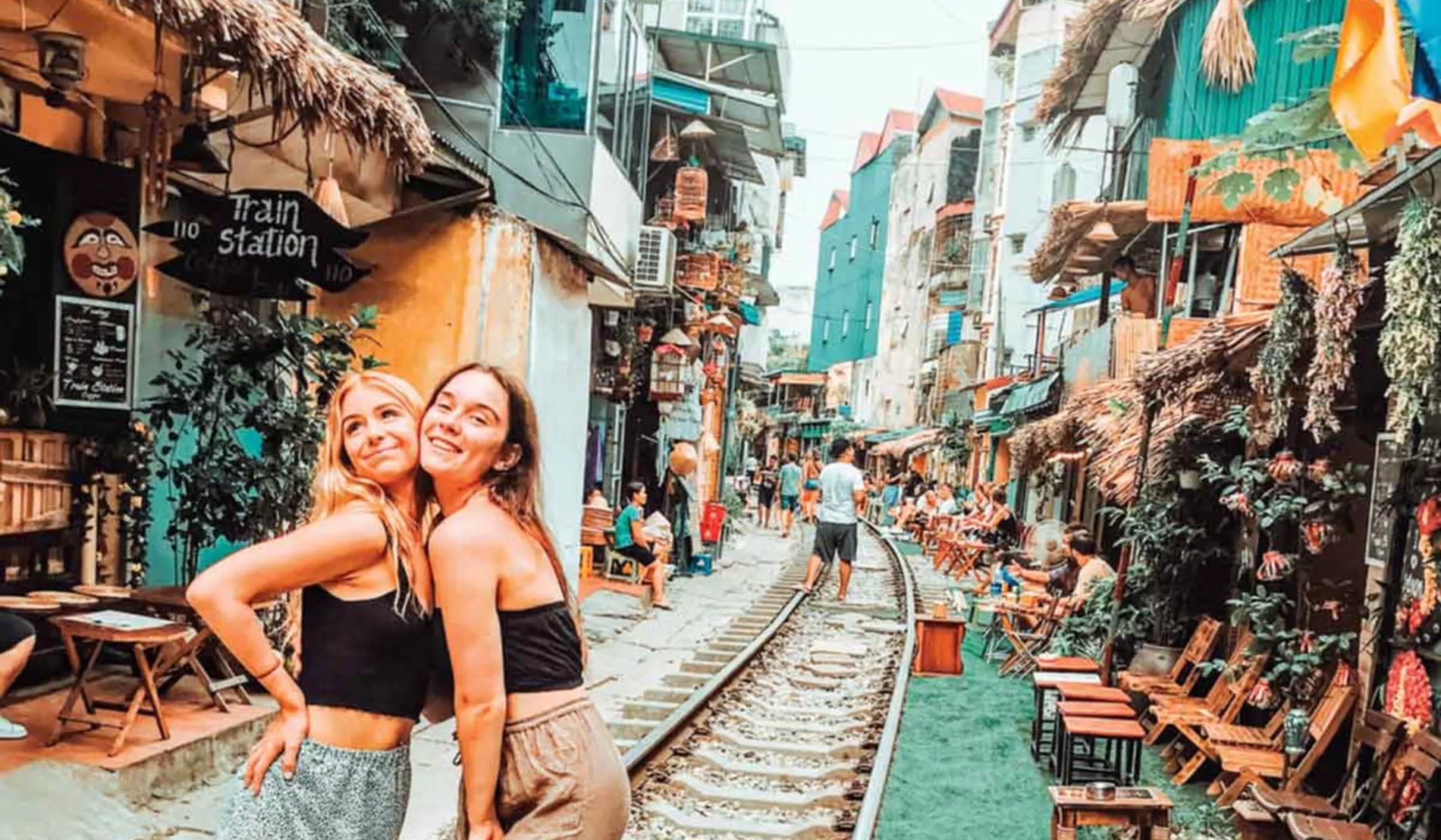 Two Happy Friends Posing For The Photo In A Busy Road