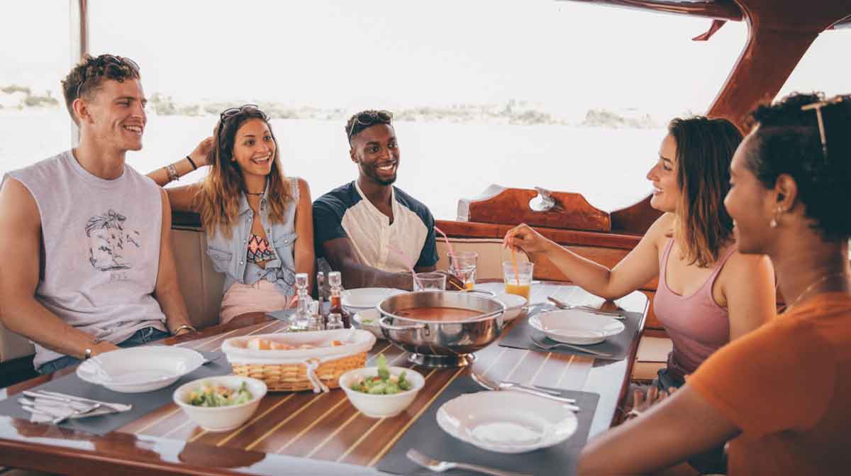 Group Enjoying Dinner On A Boat