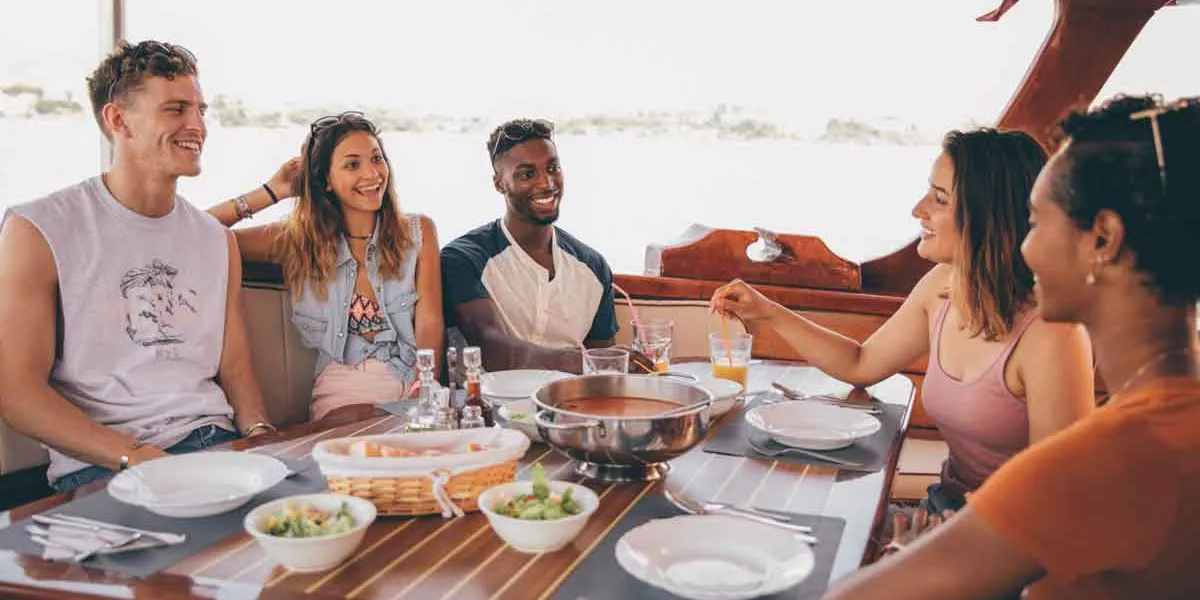 Group Enjoying Dinner On A Boat