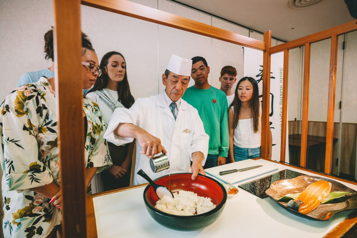 Group Of People Learning How To Do Sushi