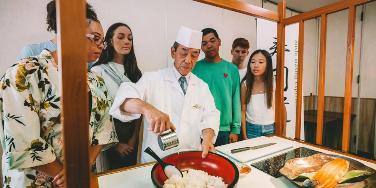 Group Of People Learning How To Do Sushi