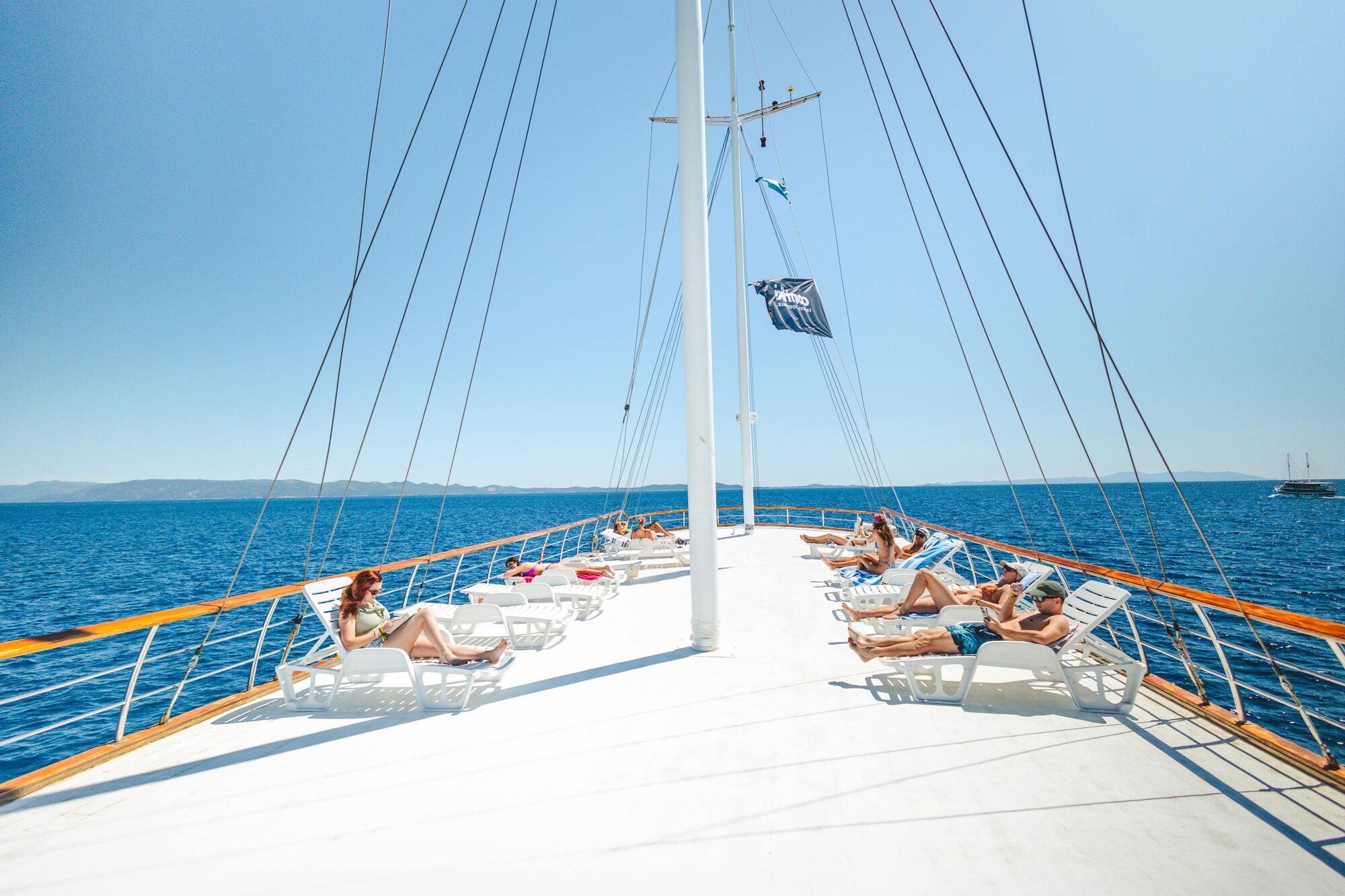 A group of people lounging on the deck of a boat