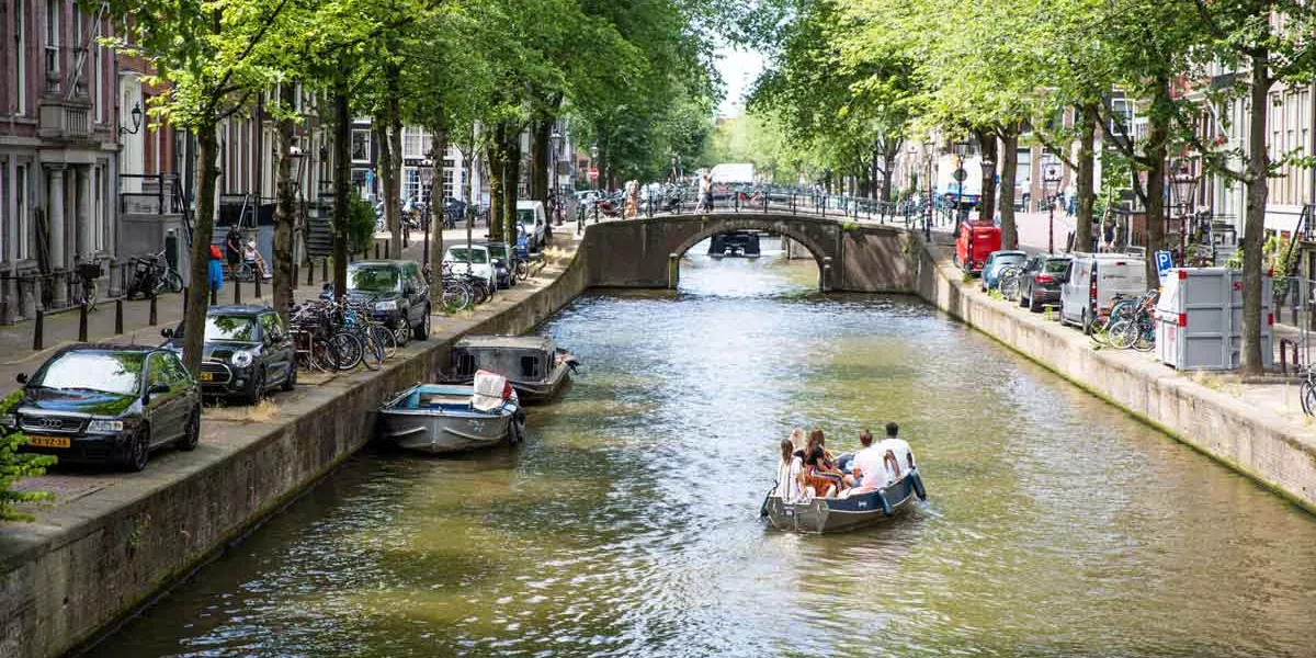 People In A Boats In Canal Sunny Day