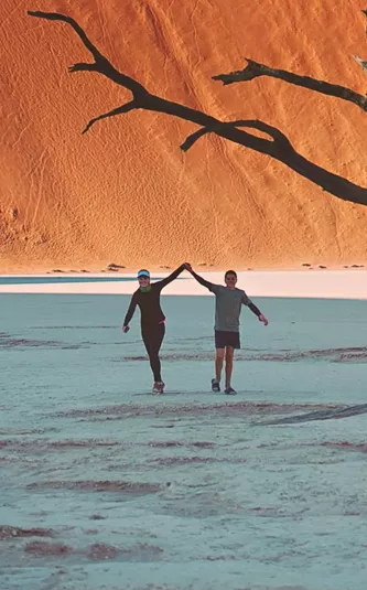 Travellers walking through Deadvlei in Namib-Naukluft National Park, Namibia - Contiki Best of Namibia Tour