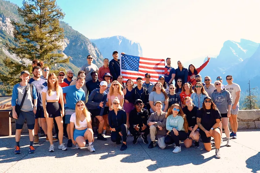 Large Group Of Young People Holding Usa Flag Park At The Back