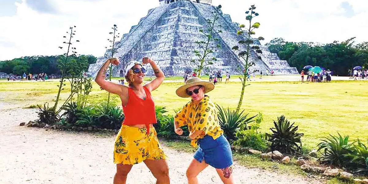 Two Women Posing For A Picture In Chichen Itza