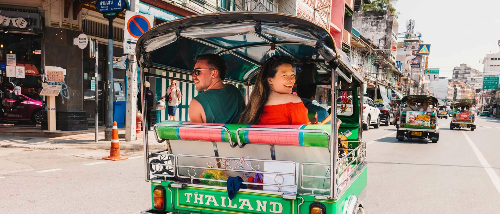 Travellers riding tuk-tuk in Thailand Travellers riding tuk-tuk in Thailand