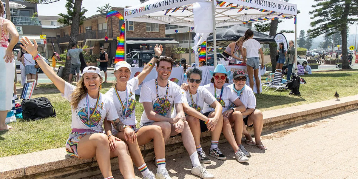Group Of Friends Sat Outside Fusion Pride Tent