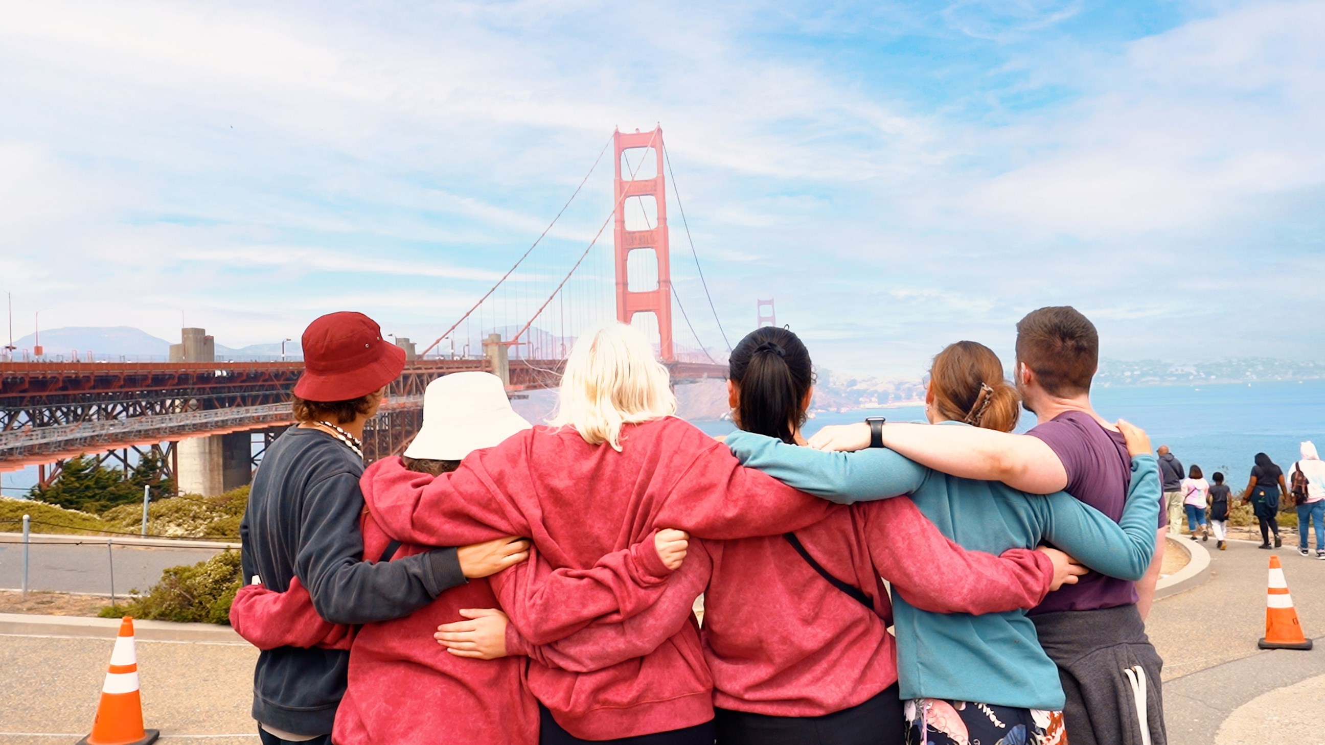 Group of Travellers Hugging in front of the Golden Gate Bridge, San Francisco, USA